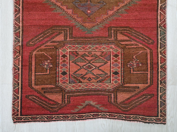 a red rug with a geometric design on it