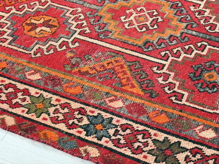 a red rug with a colorful design on it