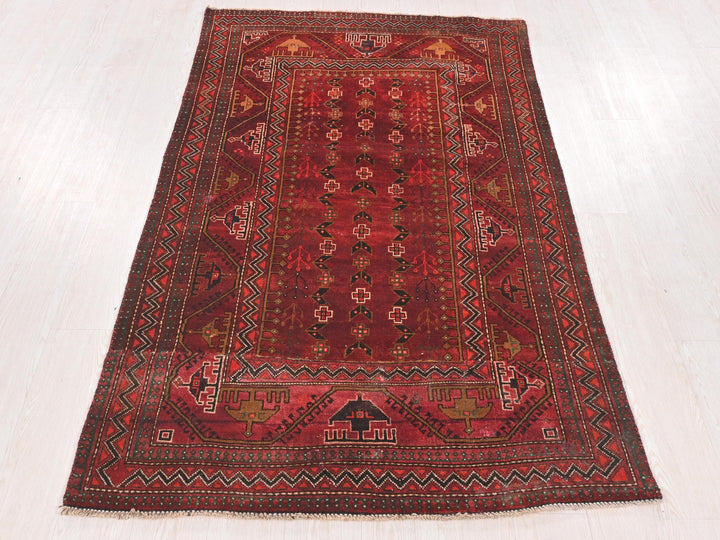 a red oriental rug on a white floor