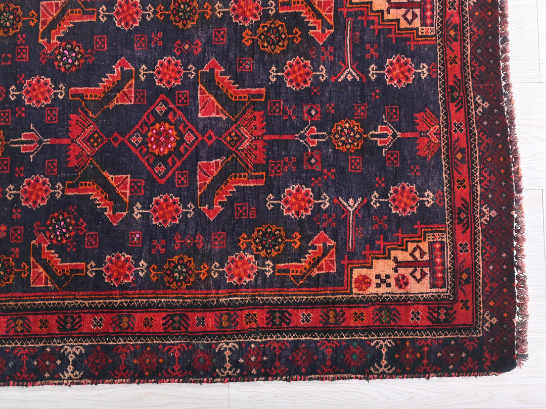 a blue rug with a red design on it