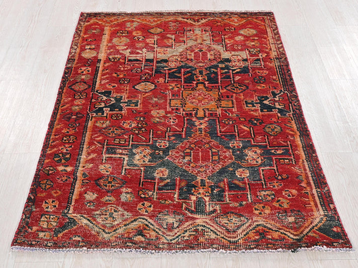 a red rug with a pattern on the middle of it