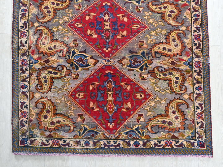 a red and blue rug on a white floor