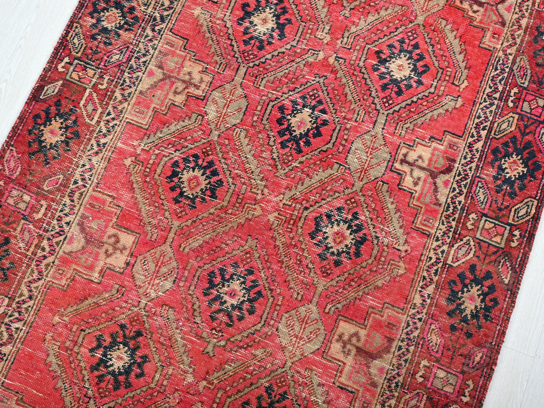 a red rug with a blue and red design on it