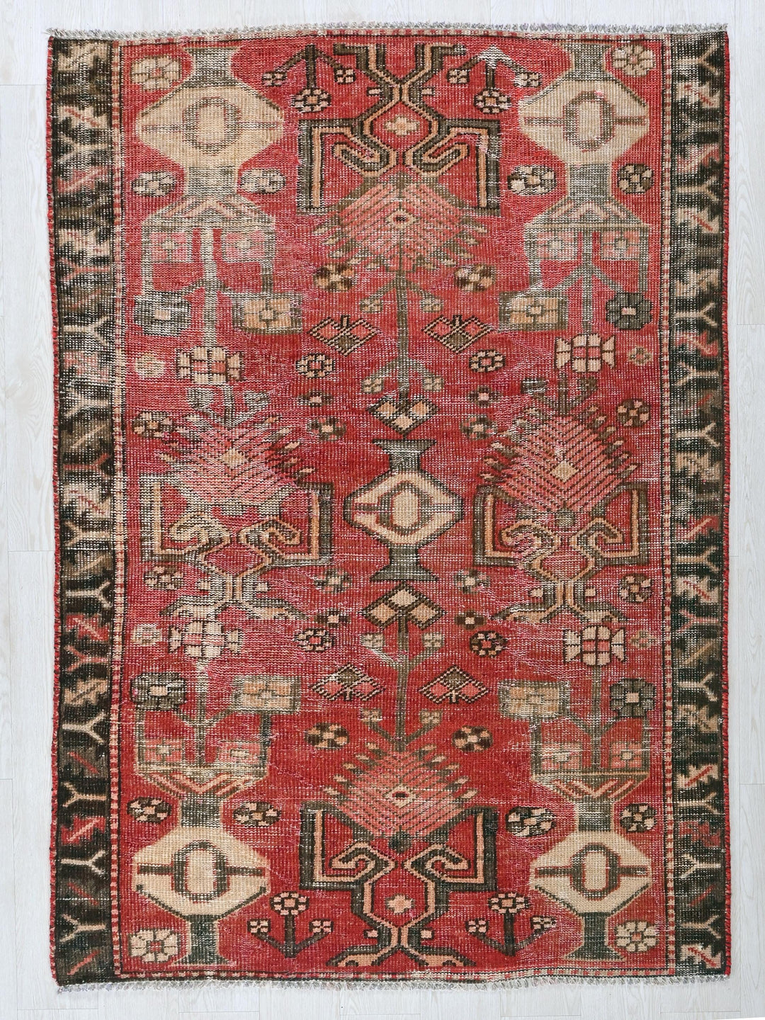 a red and black rug with a pattern on it