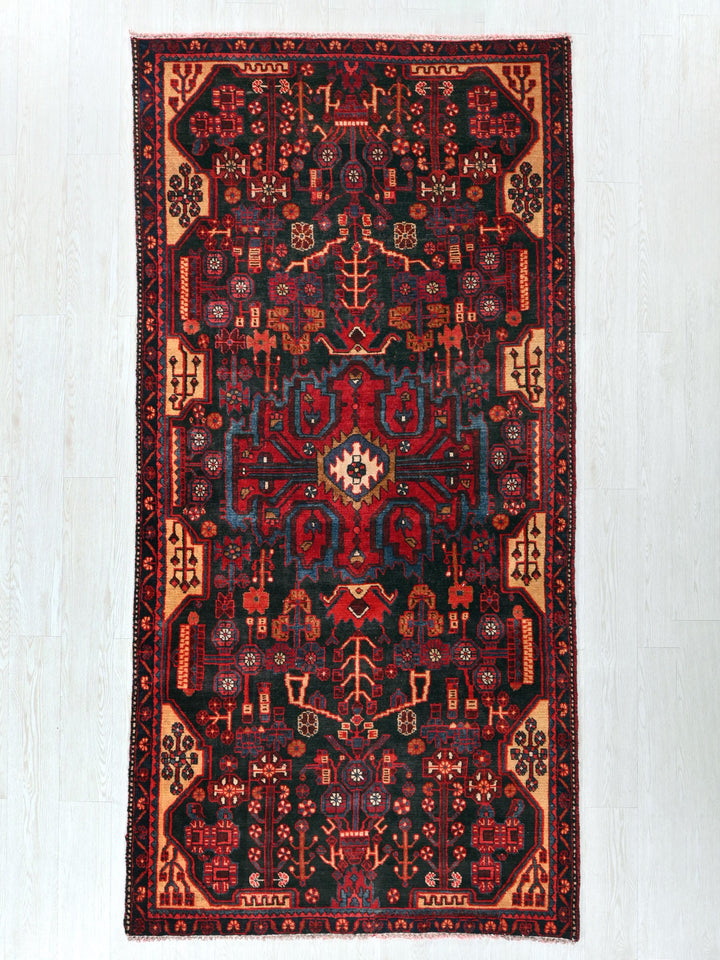 a red and black rug on a white floor