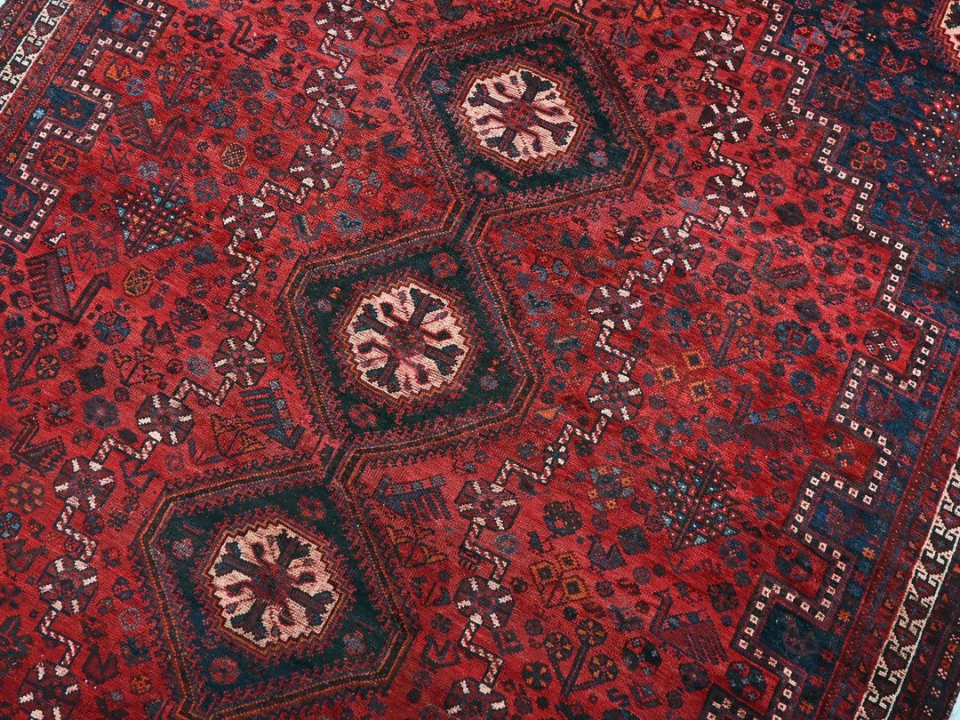 a red rug with a design on it
