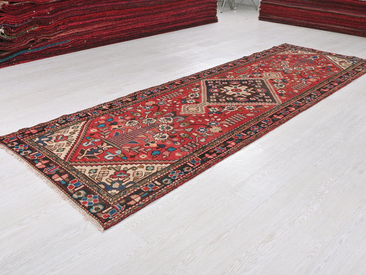 a red rug is laying on a white floor