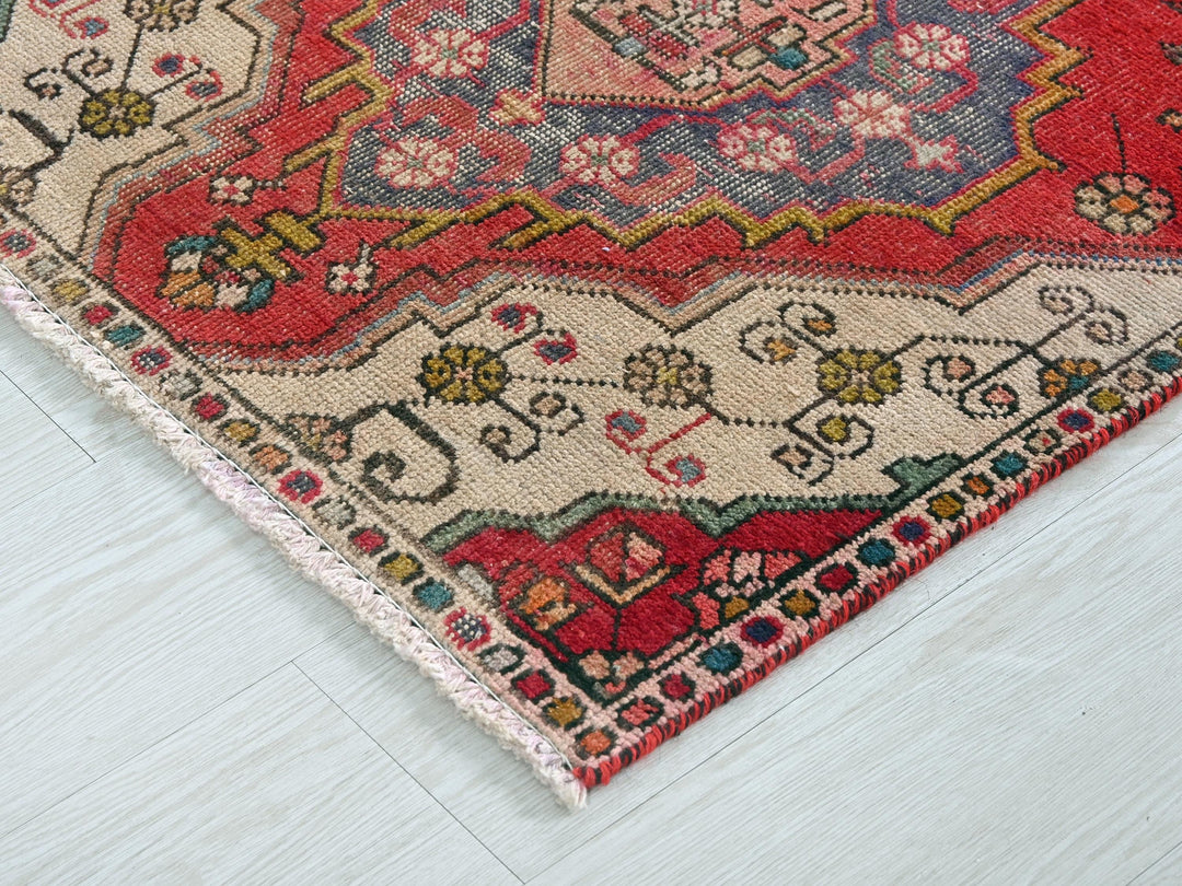 a red rug on a white wooden floor
