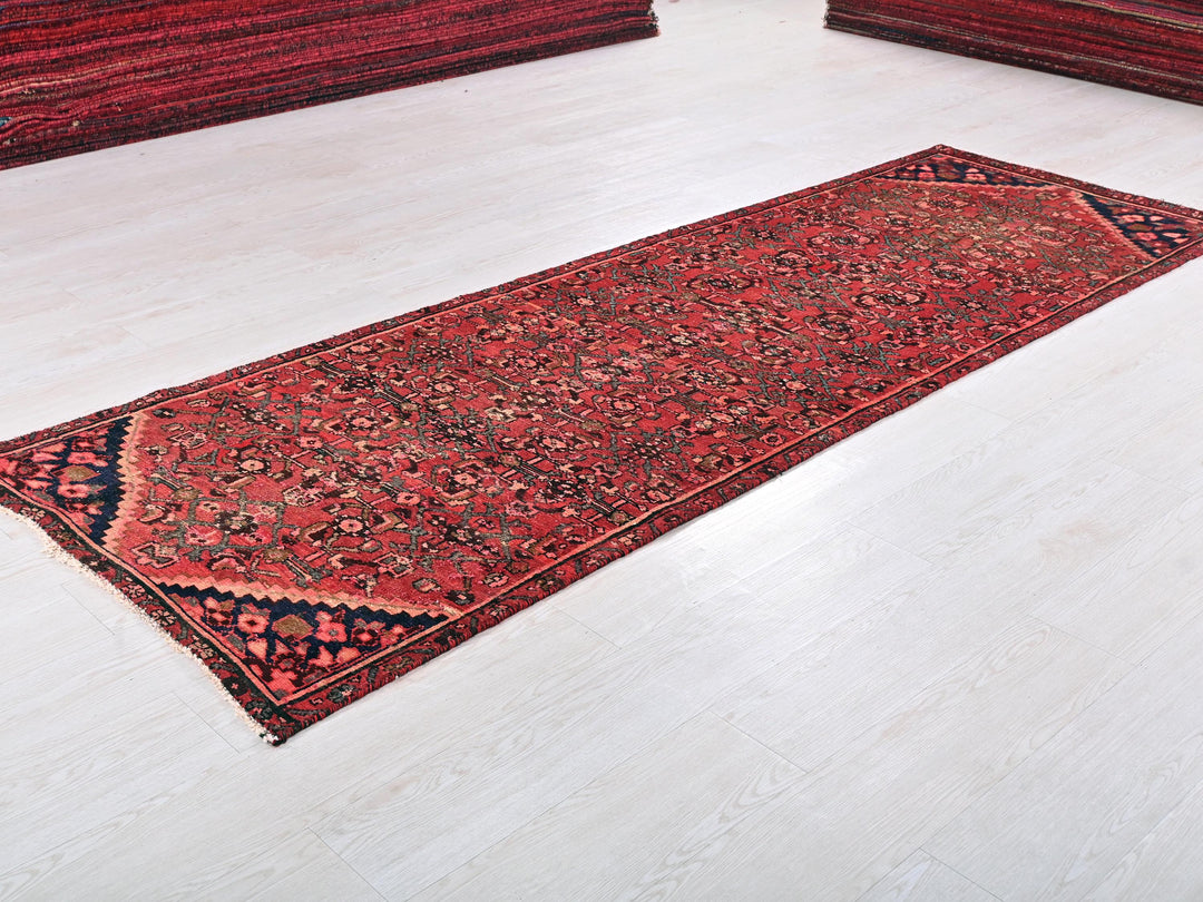 a red rug is laying on a white floor