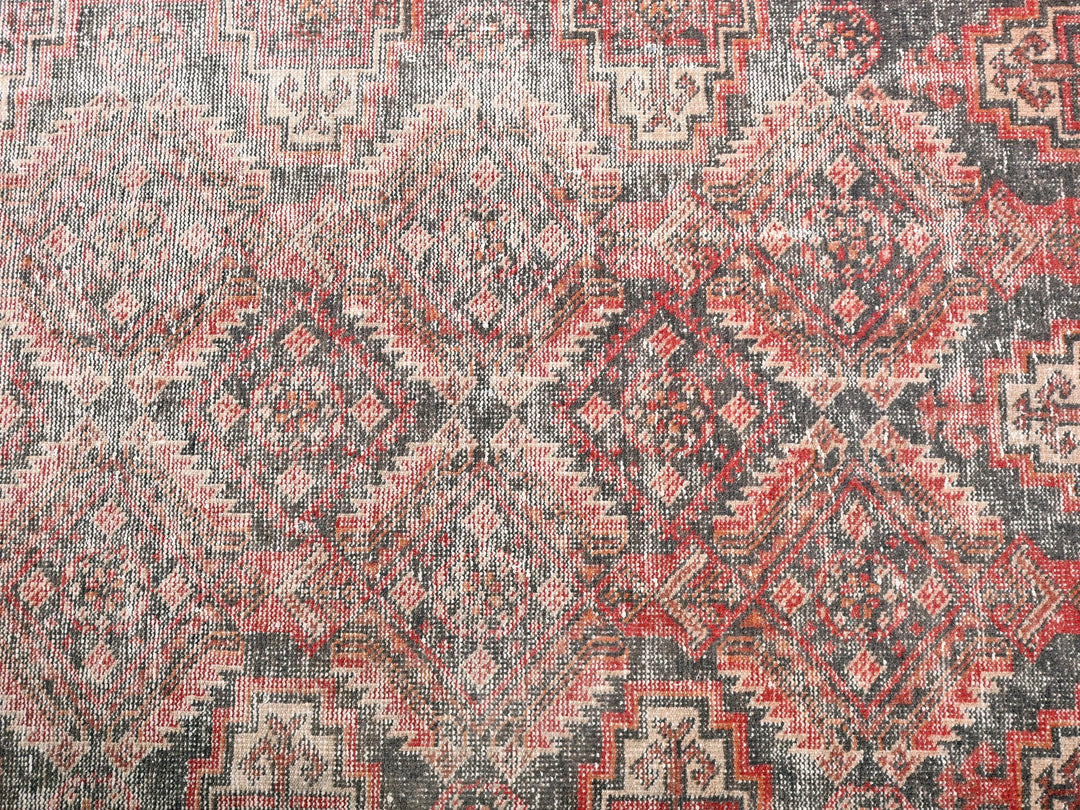 a red and black rug with a pattern on it