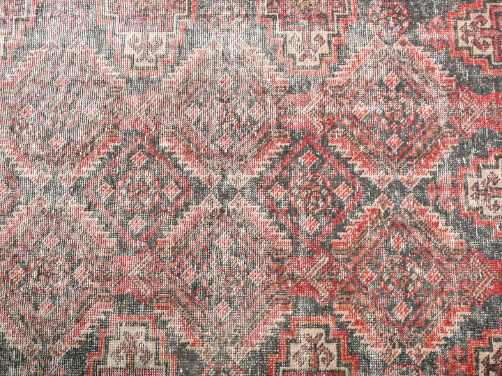 a red and black rug with a pattern on it