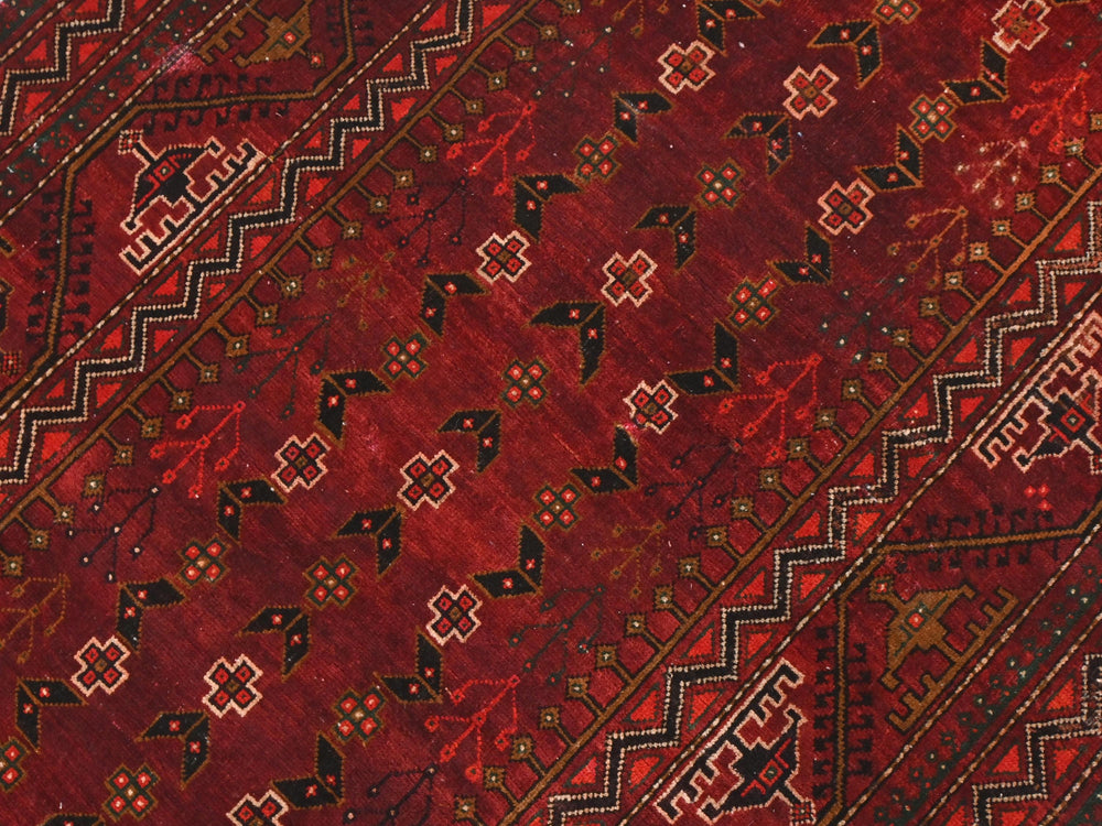 a close up of a red oriental rug