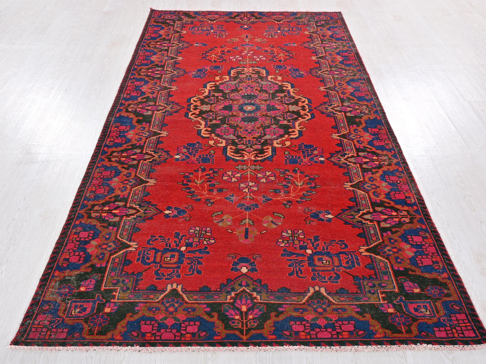 a red rug with a medallion design on it