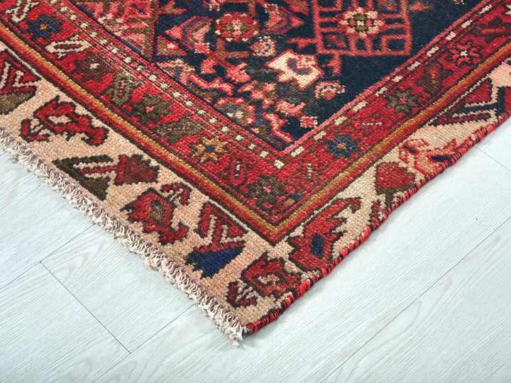 a red rug with a blue design on it