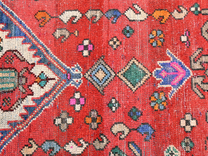a red rug with many different designs on it