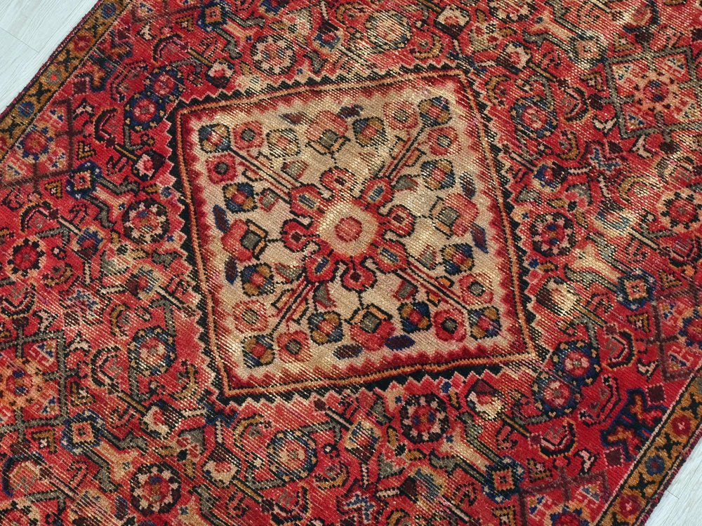 a red rug with a square design on it