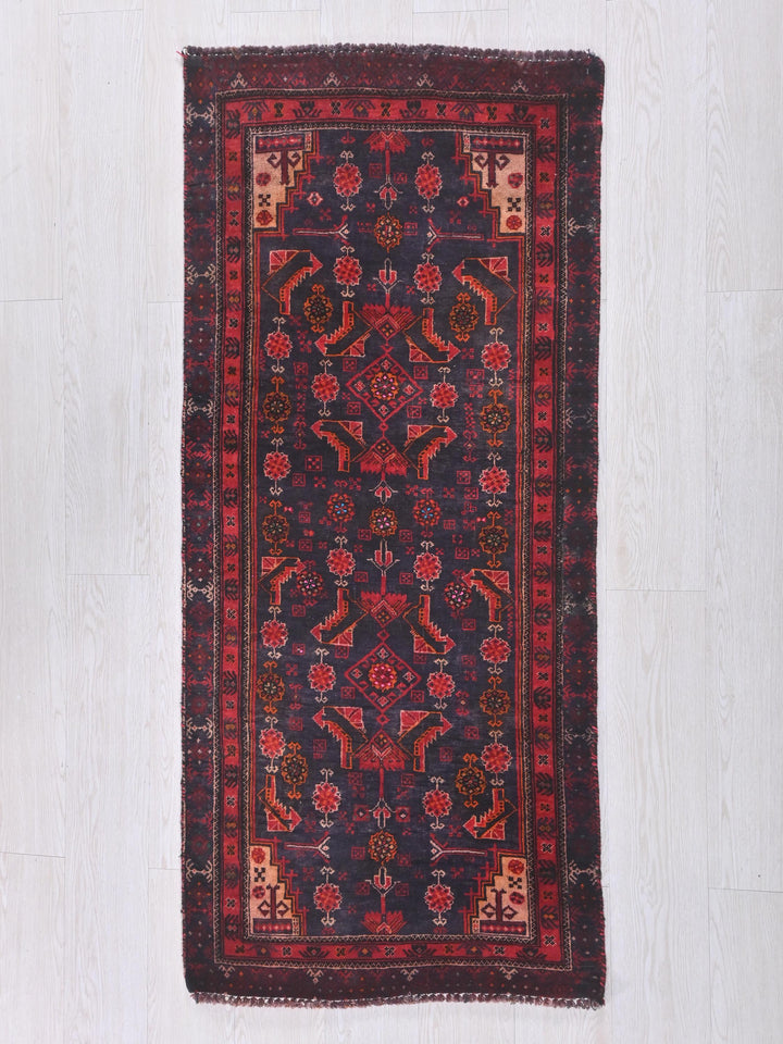 a red and blue rug on a white floor