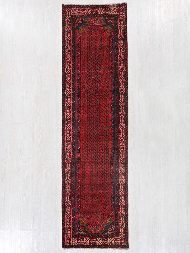 a red rug hanging up against a white wall
