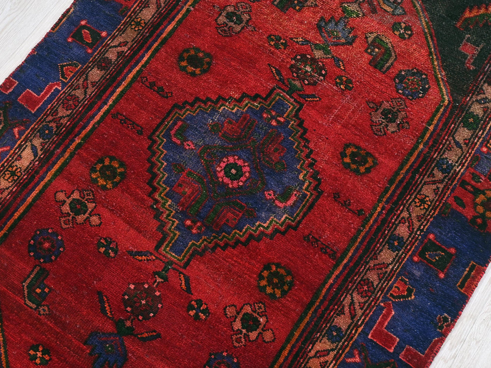 a red rug with a blue and red design on it