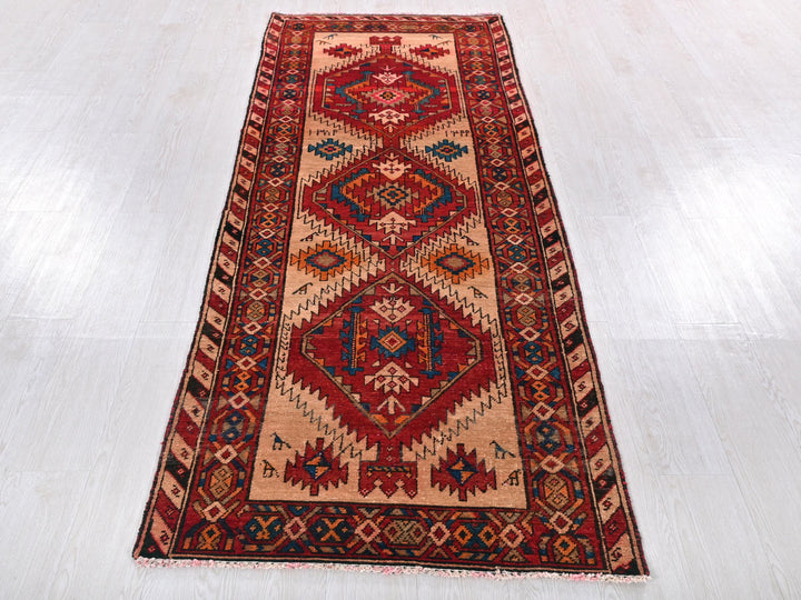 a red and blue rug on a white floor