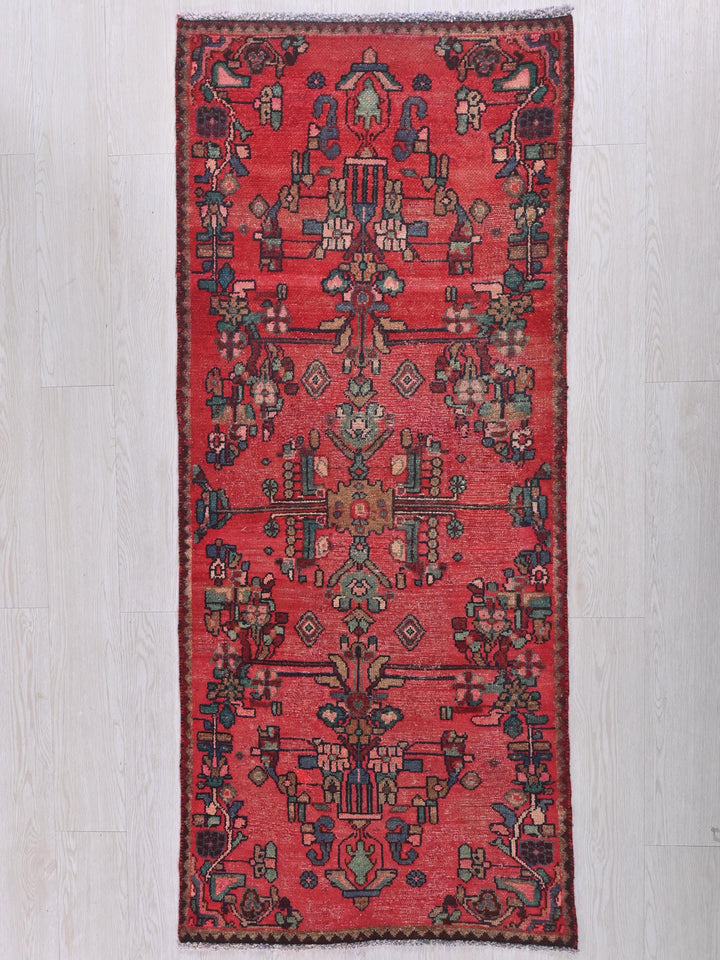 a red rug on a white wooden floor