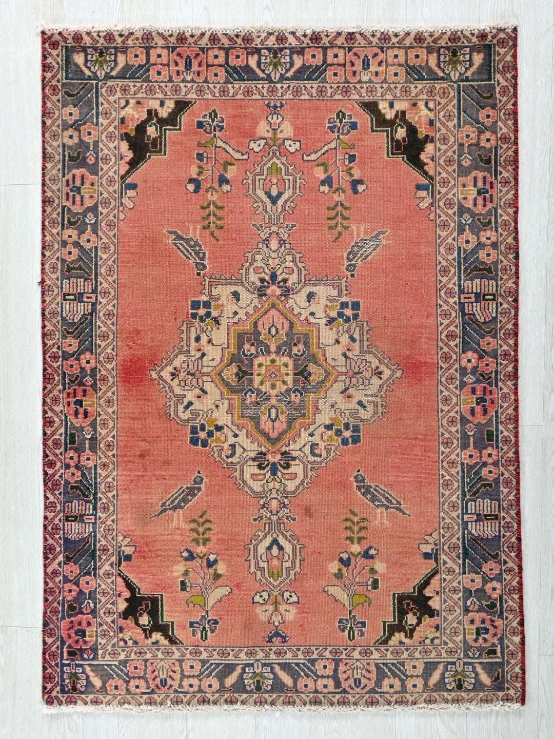 a red rug with an intricate design on it