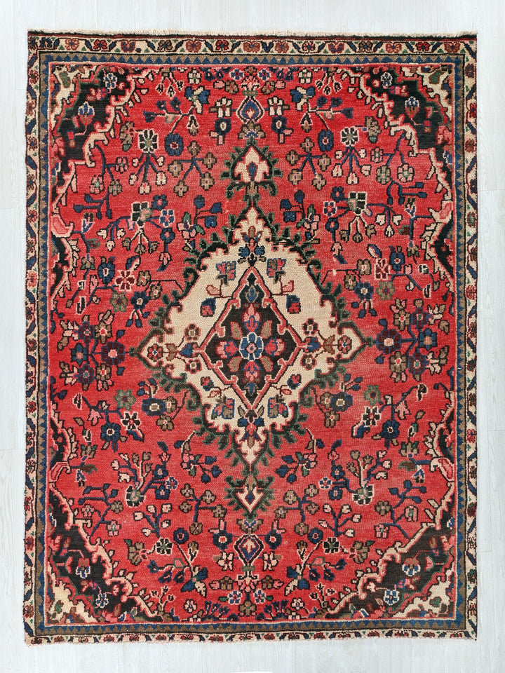 a red rug with a diamond shaped design