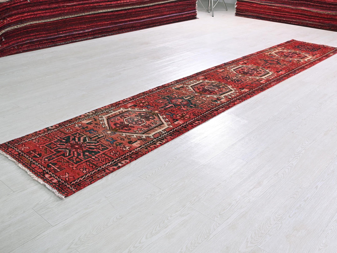 a red rug laying on a white floor