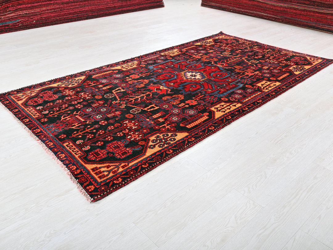 a red and black rug on a white floor