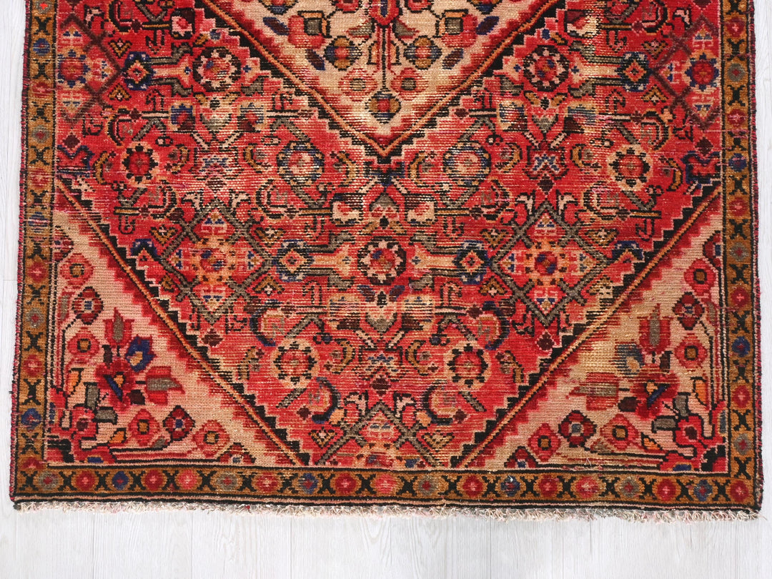 a red rug with an intricate design on it
