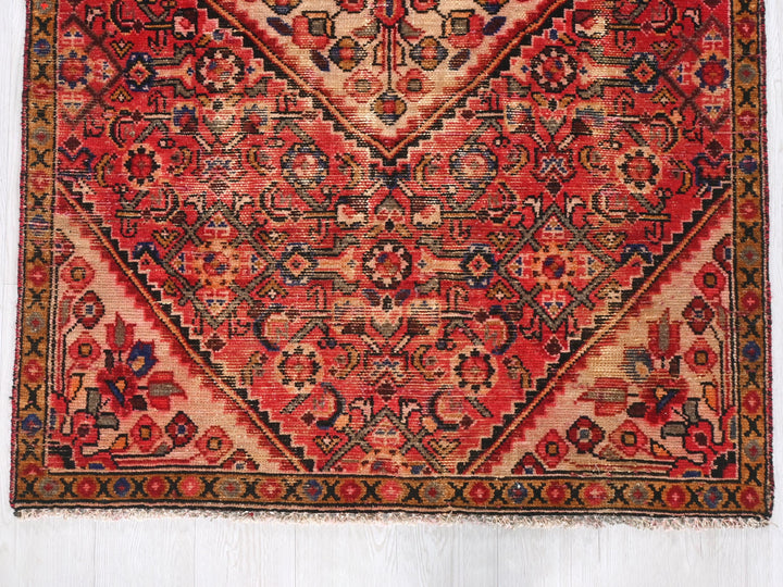 a red rug with an intricate design on it