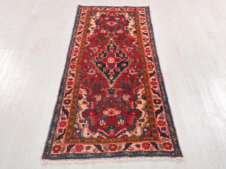 a red and blue rug on a white floor