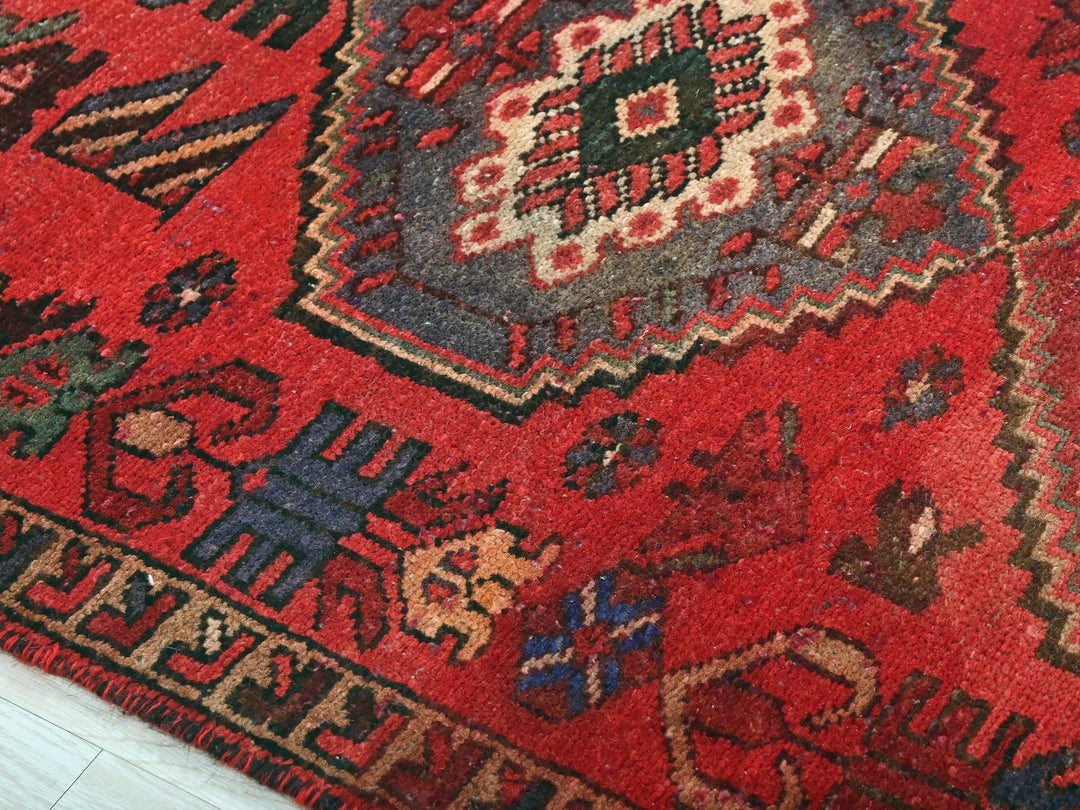 a close up of a red oriental rug