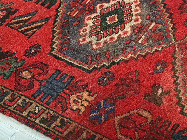 a close up of a red oriental rug
