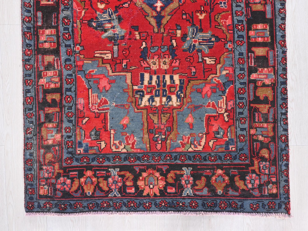 a red rug with a blue border on a white background