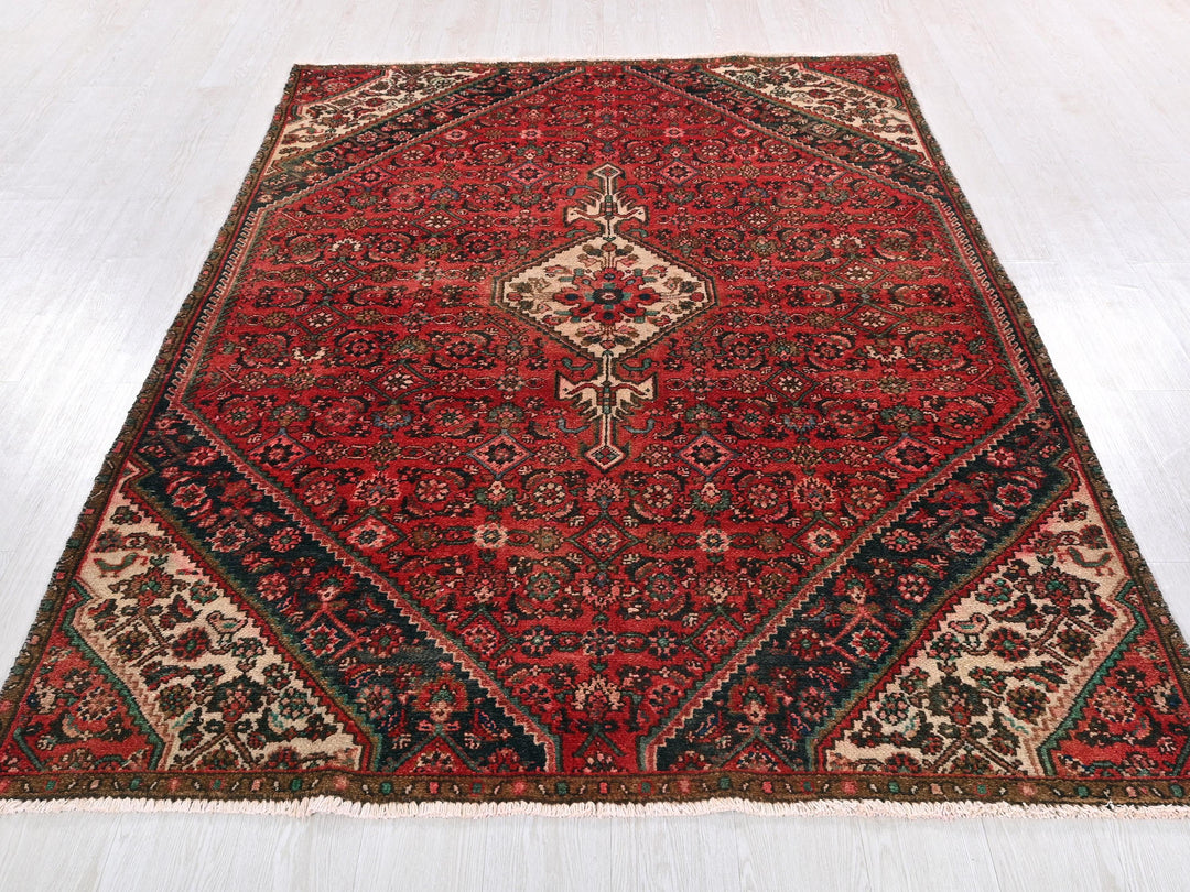 a red rug with a diamond shaped design on it