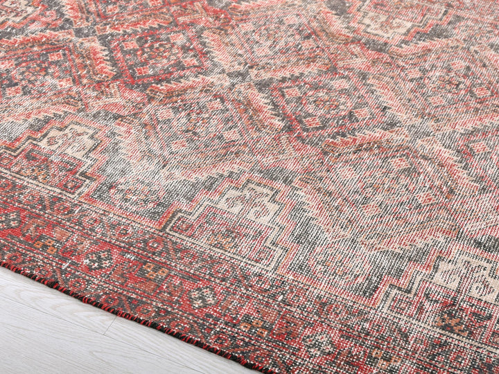 a red and gray rug with a pattern on it
