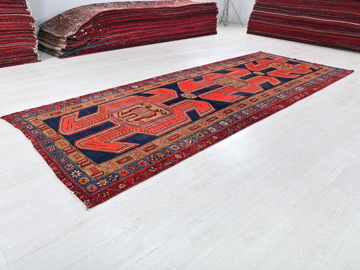 a pile of red rugs sitting on top of a white floor
