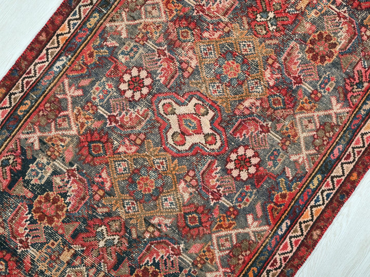a red and blue rug on a white floor