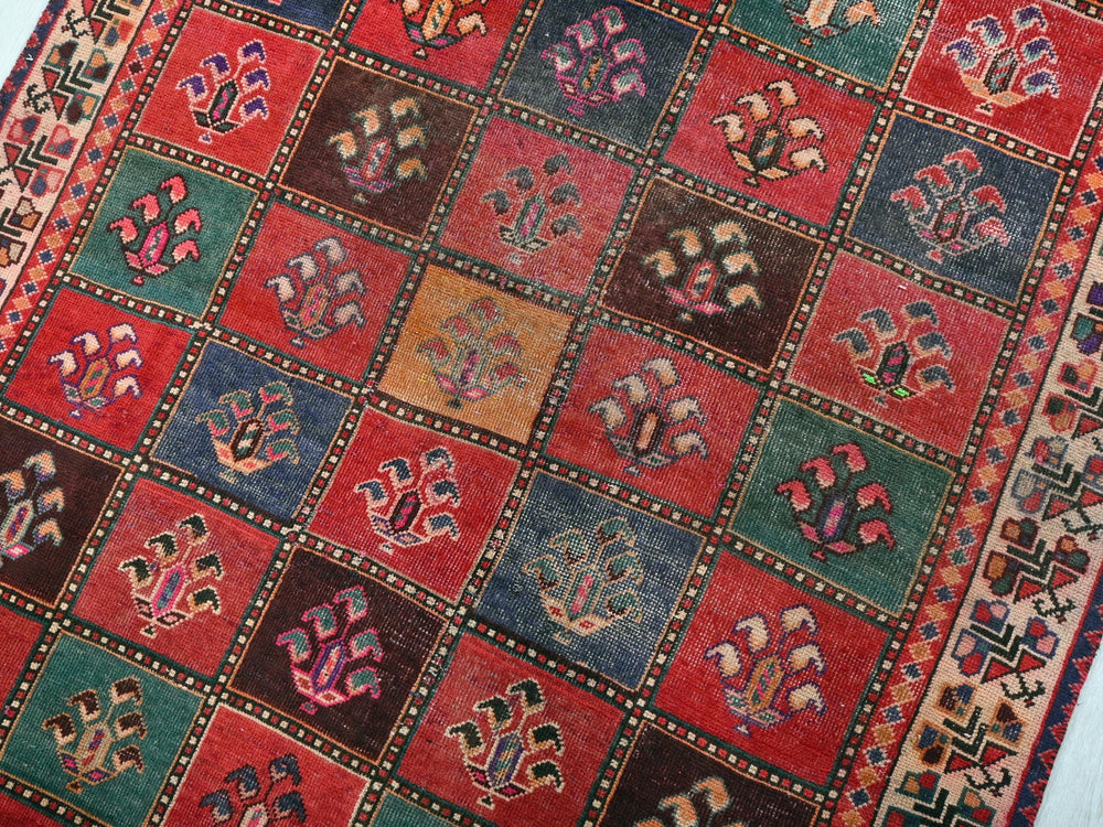 a multicolored rug on a white floor