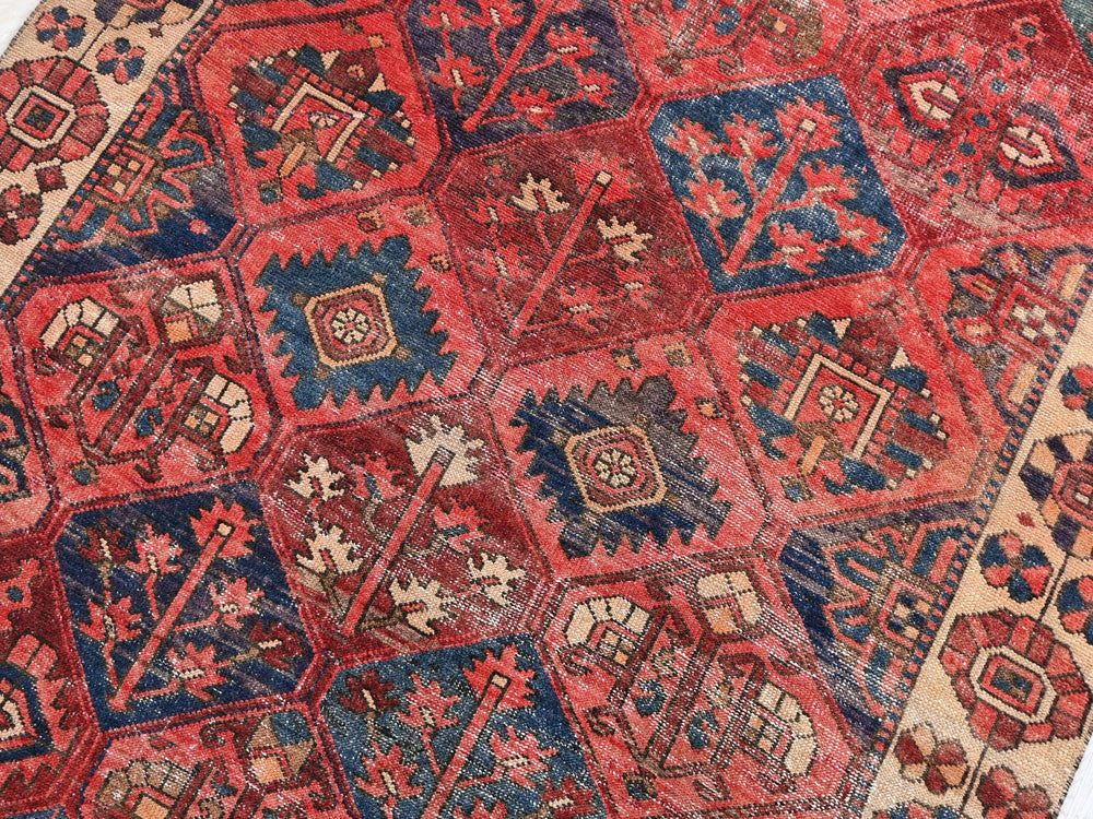 a red and blue rug with many different designs