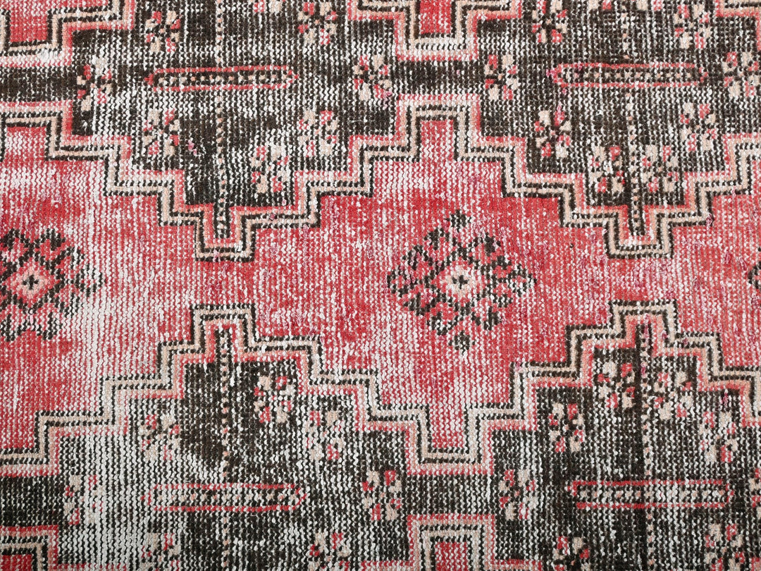 a close up of a red and black rug