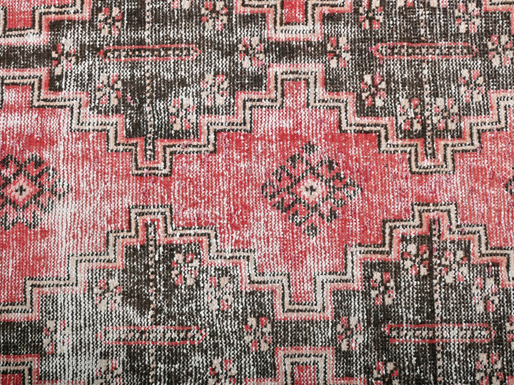 a close up of a red and black rug