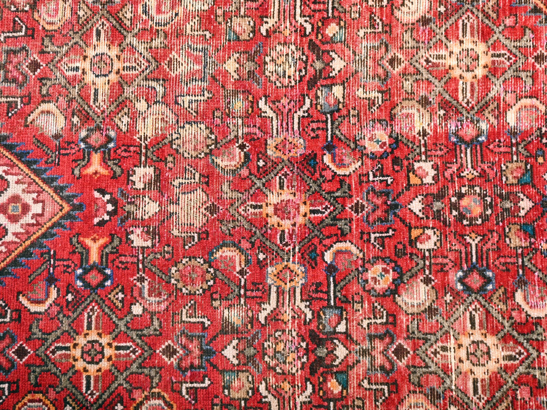 a red rug with a pattern on it