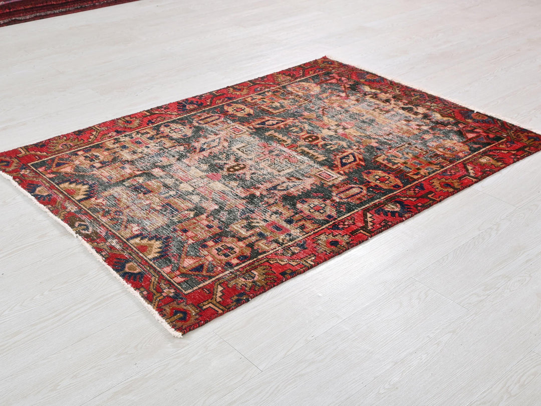 a red and black rug on a white floor