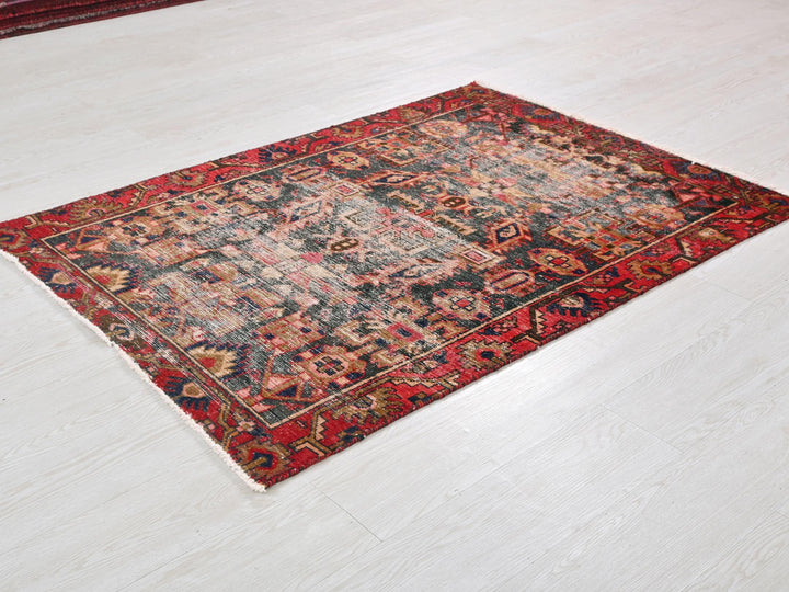 a red and black rug on a white floor