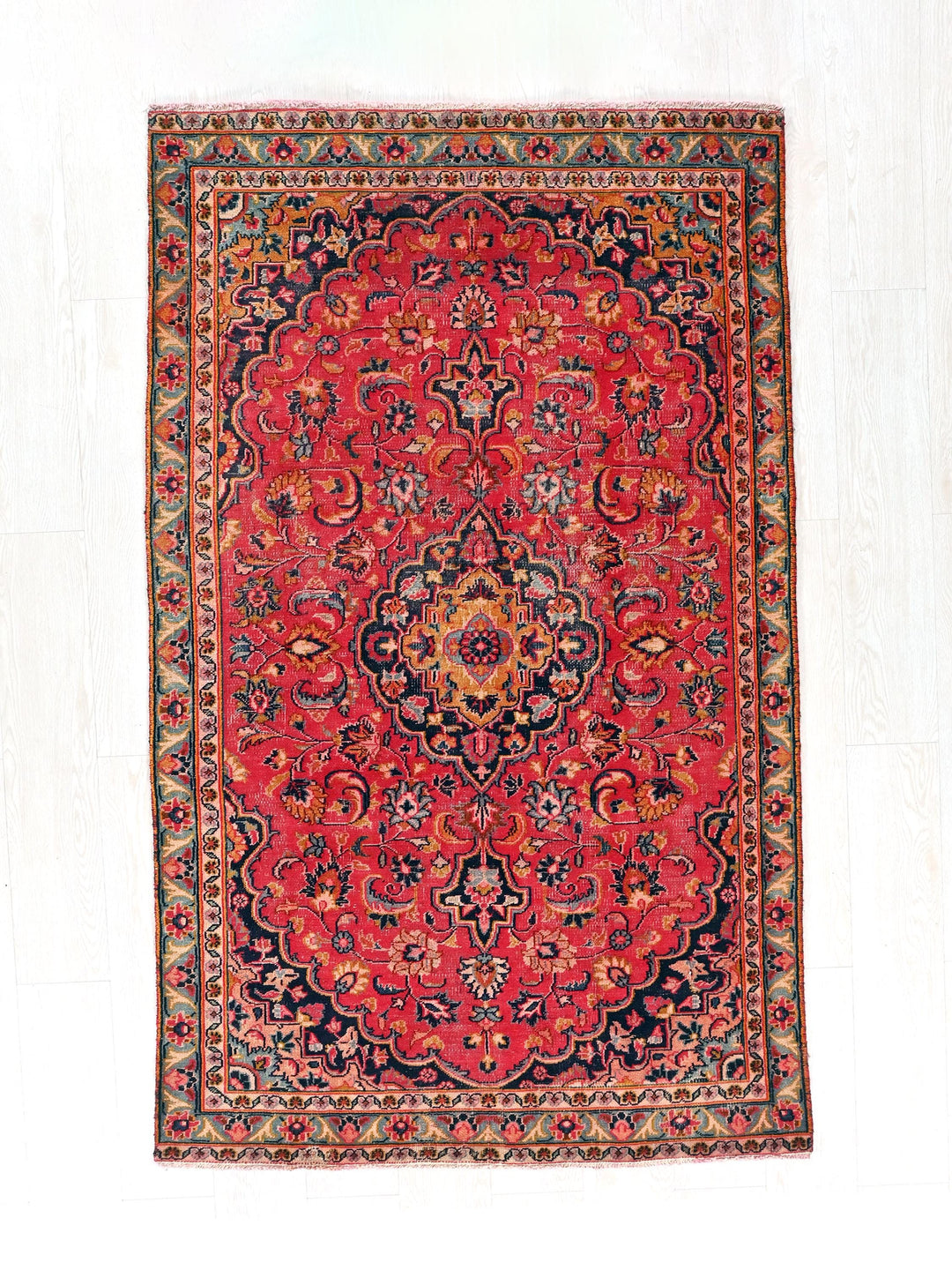 a red rug with a black and red design on it