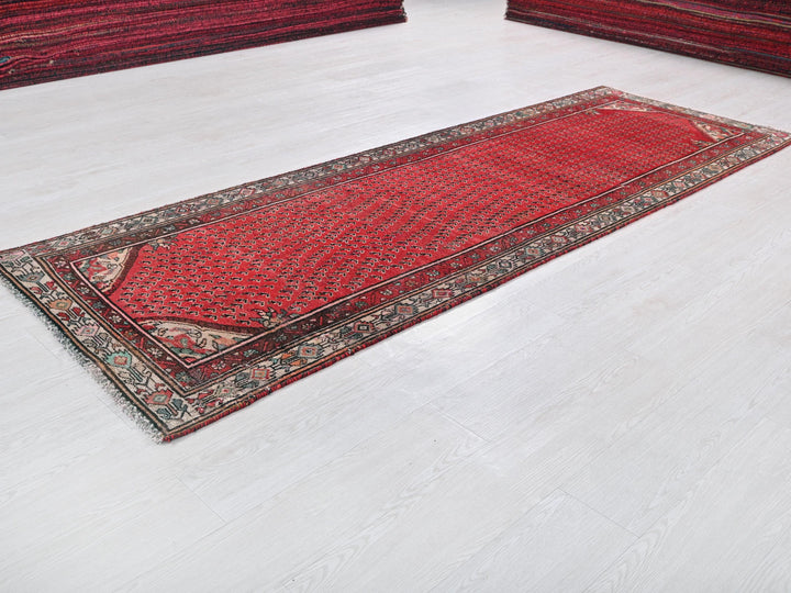 a red rug is laying on a white floor