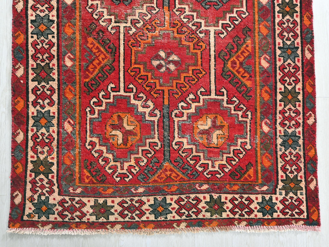 a red rug with an intricate design on it