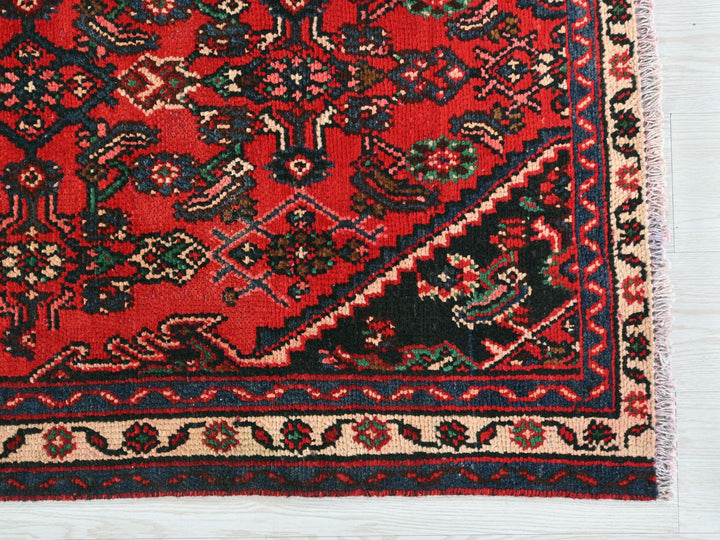 a red rug with a black border on a white background